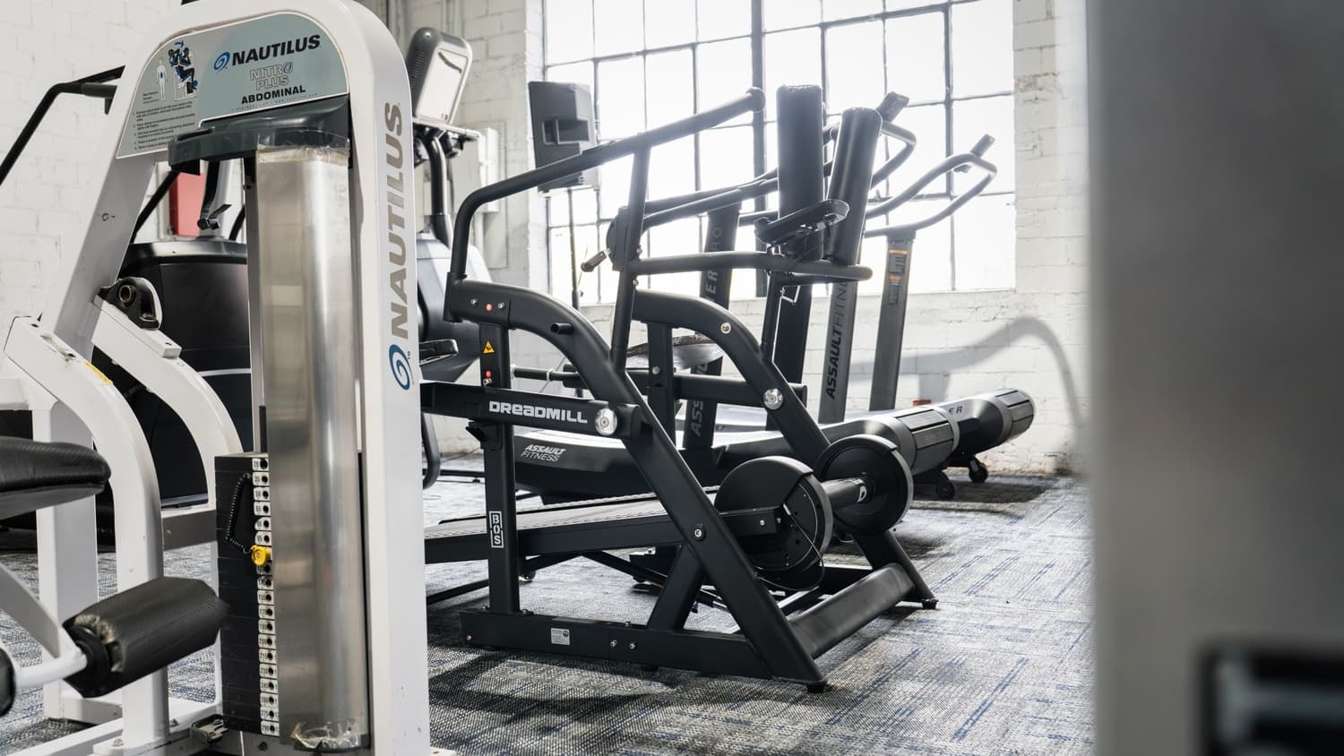 Machine zone with cardio equipment at Indy City Barbell