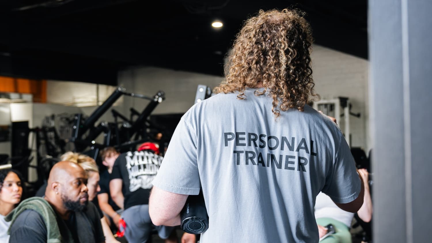 Personal trainer coaching a group class at Indy City Barbell, Indianapolis